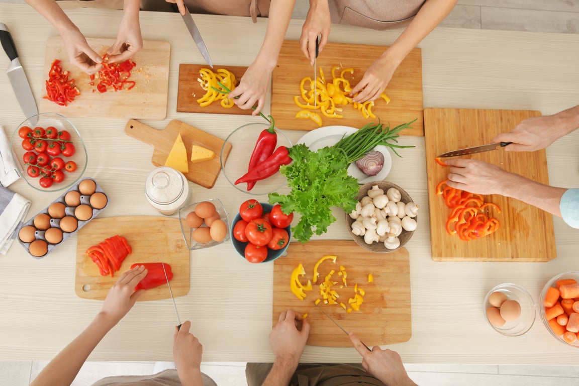 People Cutting Vegetables at Cooking Classes